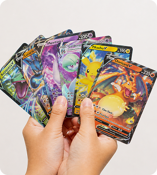 Hand holding a fan of colorful Pokémon cards